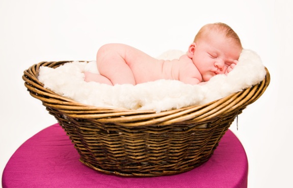 Baby girl sleeping in a basket