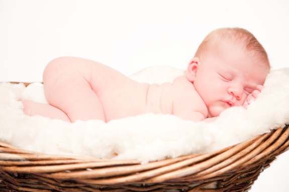 Baby girl sleeping in basket